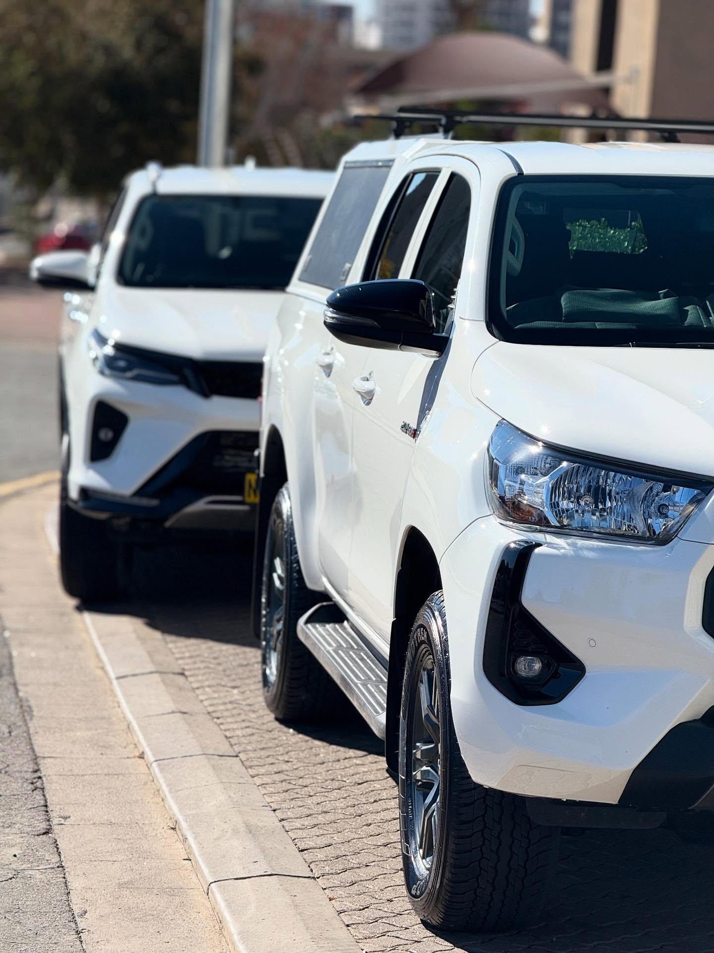 New Trend Car Rental vehicles lined up ready for airport transfers